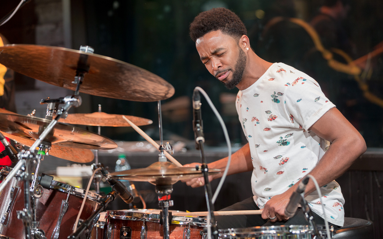 Ryan J Lee playing drums, photo by Daniel Sheehan.