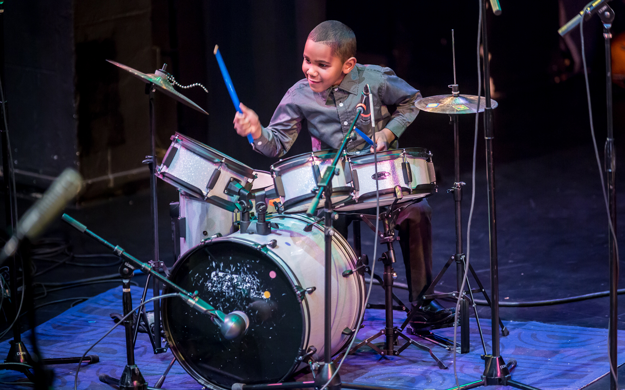 Donovon Kranzler-Lewis playing drums, photo by Daniel Sheehan.