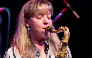 Kate Olson playing a saxophone