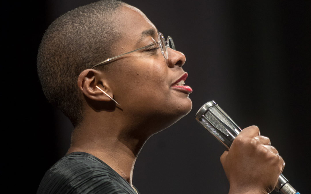 Cécile McLorin Salvant singing, holding a microphone