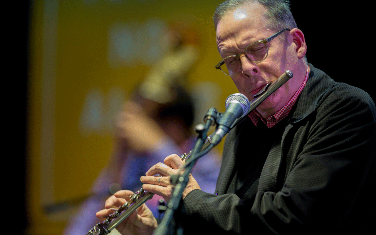 Hans Teuber playing a flute very close to the microphone.